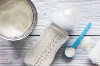 Du lait en poudre et un biberon posés sur une table